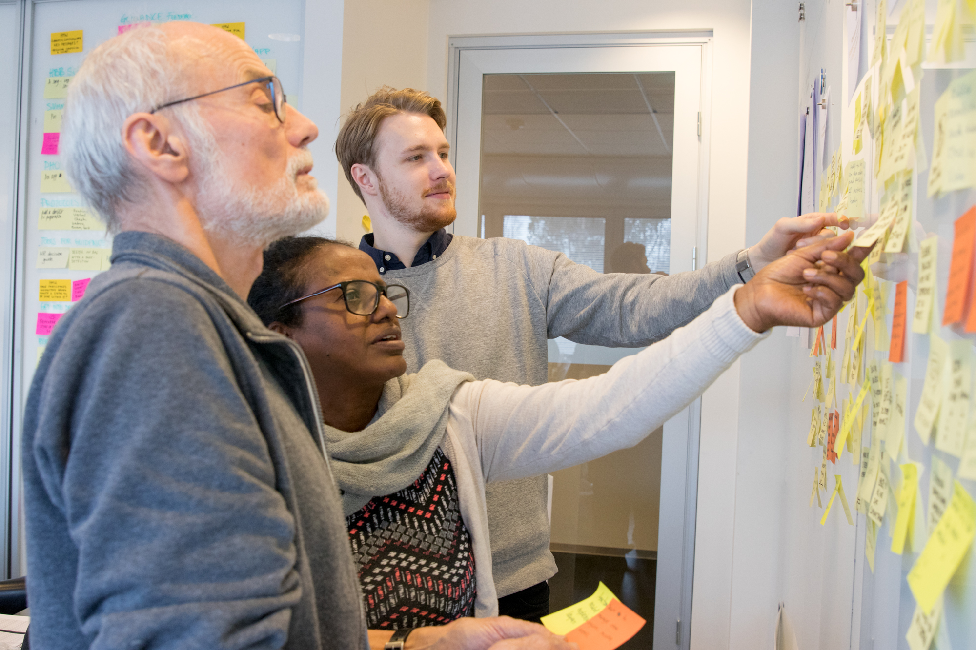 A team working together with notes on a board